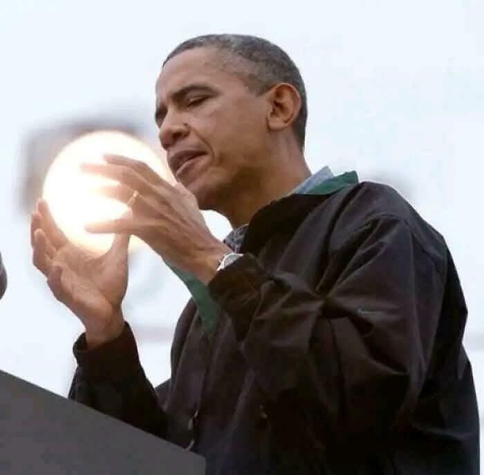 A person appears to be holding a glowing light due to the confusing perspective.